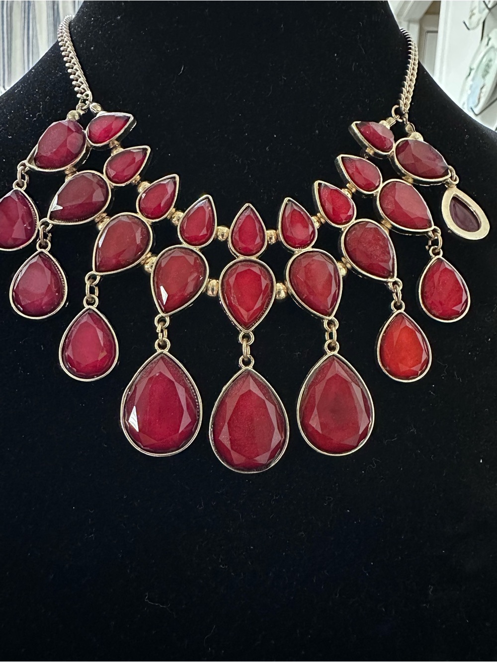 Claire's necklace features a striking gold-tone bib